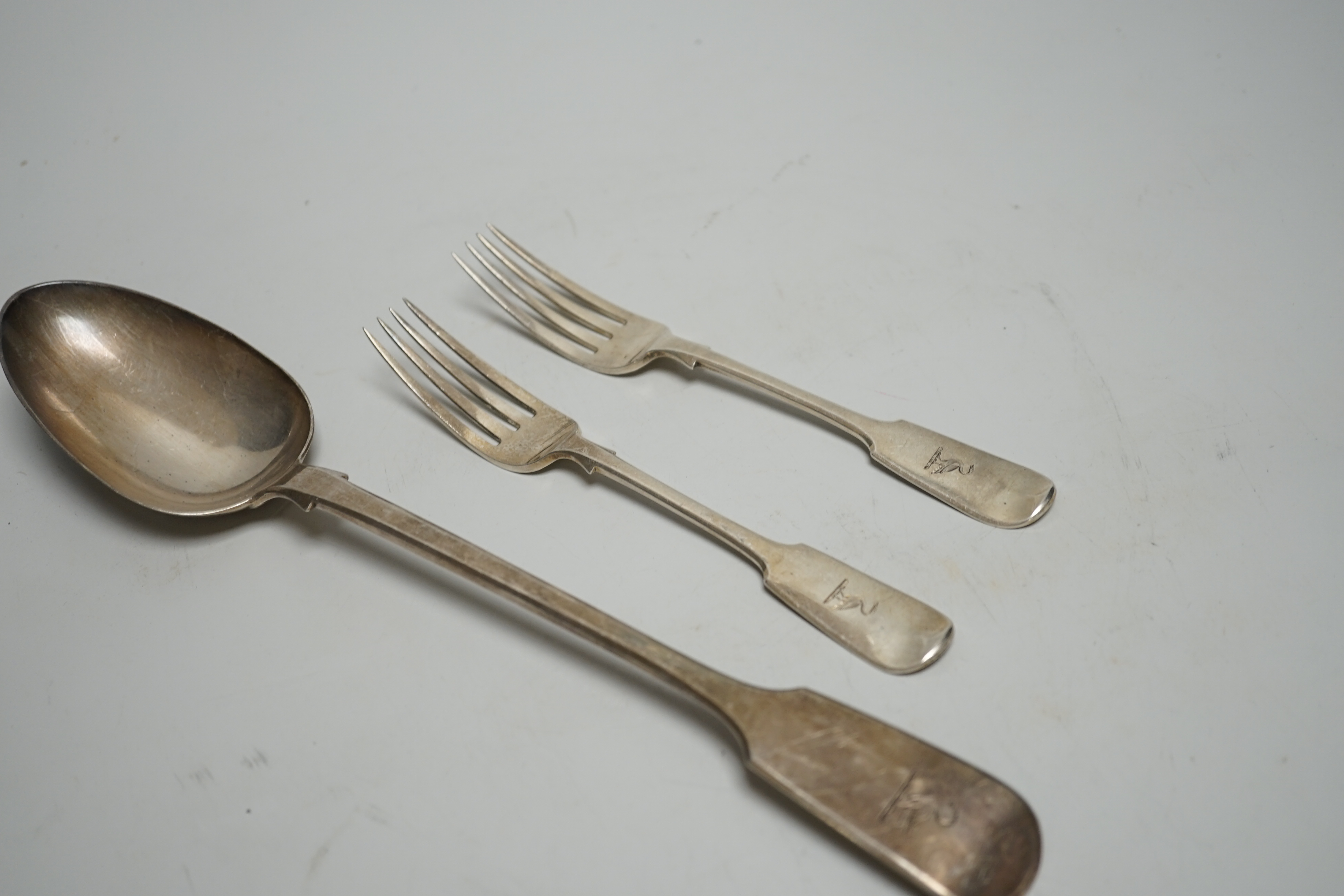 A Victorian silver fiddle pattern basting spoons, Charles Wallis, London, 1852, 30.4cm and a pair of Victorian provincial silver dessert forks, Josiah Williams & Co, Exeter, 1862, 7.6oz.